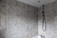 New bathtub and wall tiles after leak identified and fixed