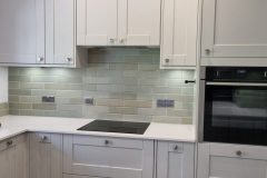 Howdens Fairford Dove Grey, White storm stone worktops and galapagos mint green tiles