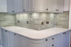 Howdens Fairford Dove Grey, White storm stone worktops and galapagos mint green tiles