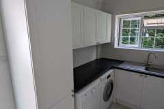Howdens Witney matt white units in a utility room