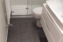 Replacement of floor tiles and a new sliding shower door